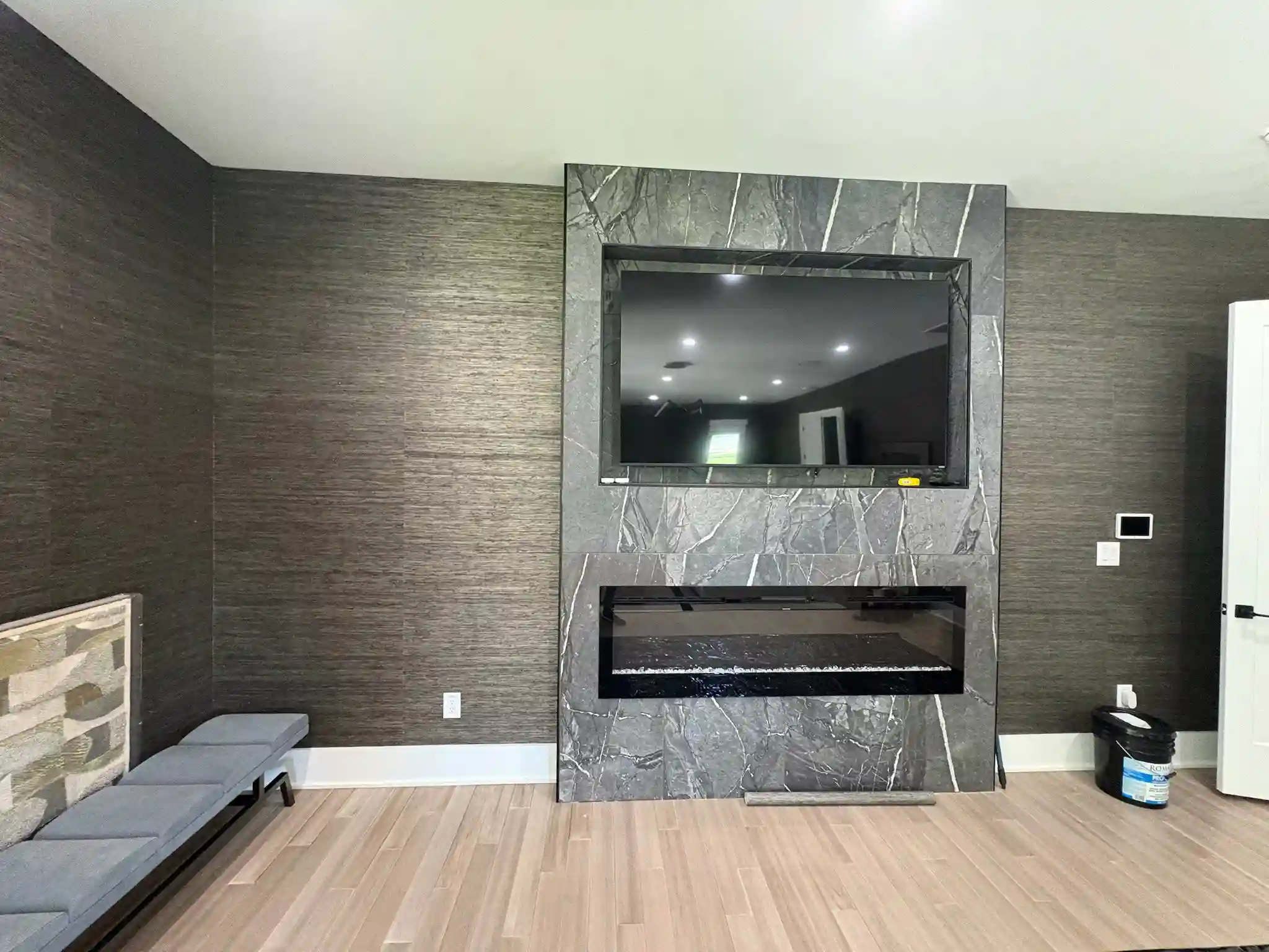 Dark wallpaper wall surrounding a fireplace