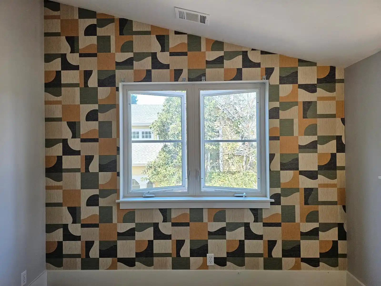Geometric wallpaper pattern around a window